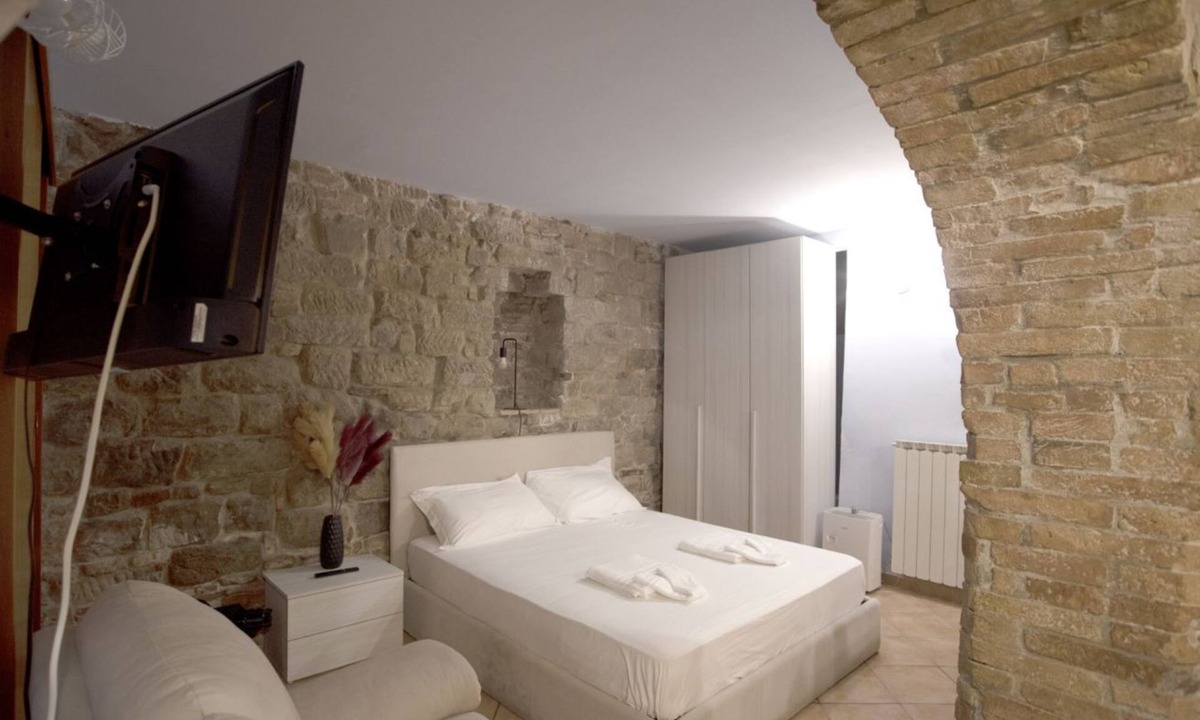 Old Town Apartment | Cozy suite in the heart of Perugia, perfect for 2 guests.Elegant room, comfortable living room and kitchen equipped to feel right at home.The unique detail? The natural stone walls, which give charm and character to the environment.Bright and well-kept,
