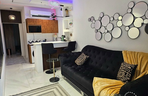 Riyadh Apartment | Chic 1-bedroom living room kitchen small garden. with WiFi, AC in Riyadh