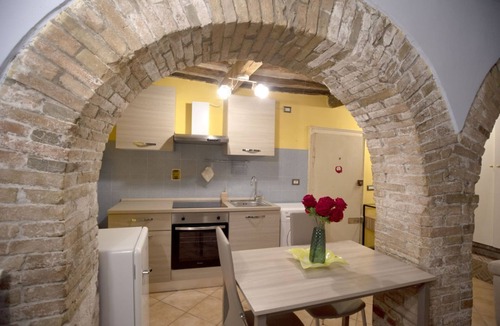 Old Town Apartment | Cozy suite in the heart of Perugia, perfect for 2 guests.Elegant room, comfortable living room and kitchen equipped to feel right at home.The unique detail? The natural stone walls, which give charm and character to the environment.Bright and well-kept,