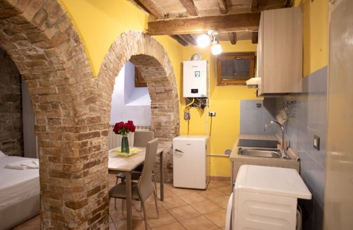 Old Town Apartment | Cozy suite in the heart of Perugia, perfect for 2 guests.Elegant room, comfortable living room and kitchen equipped to feel right at home.The unique detail? The natural stone walls, which give charm and character to the environment.Bright and well-kept,