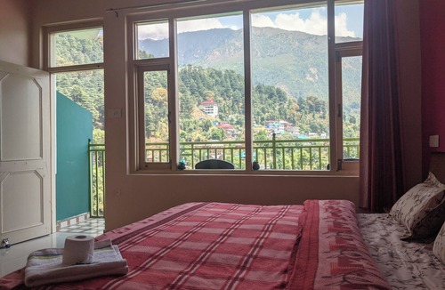 McLeod Ganj Bed & Breakfast | Golden View BnB Mcleodganj Room with private balcony facing mountain view.