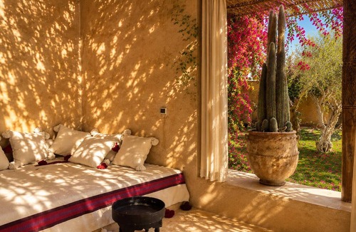 Oumnass House | Pool-view romantic bedroom