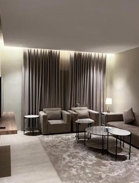 A suite with a room and a lounge with a quiet and modern design