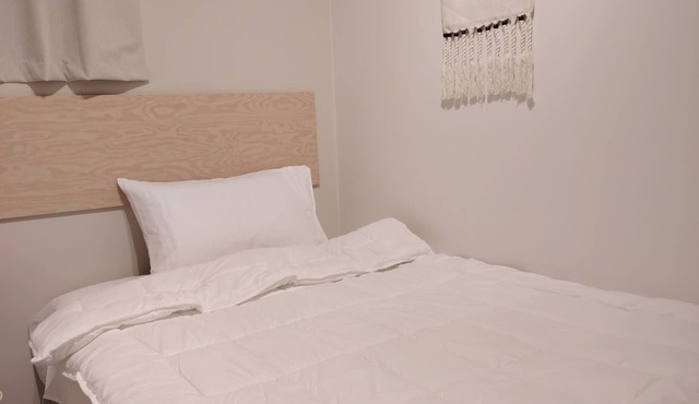 Private room 8m for men. Bed, AC, side table, Wi-Fi. Shared baths, lounges.